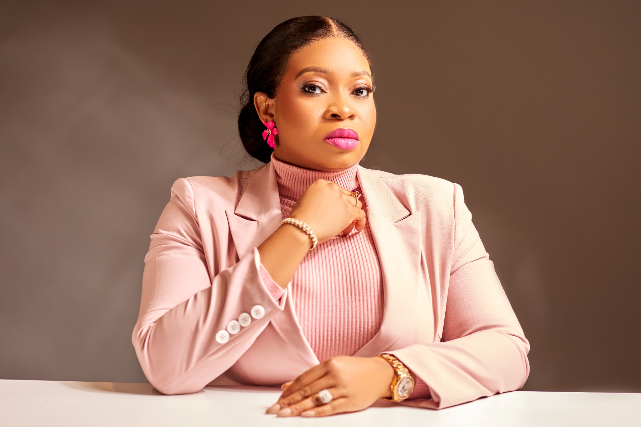 Funmilayo Adeola, founder of SwanPro Cosmetics, seated at her desk